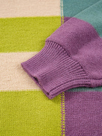 Close-up of a purple knitted fabric on a multicolored geometric-patterned surface
