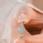 Diamond earring being worn on a blurred background