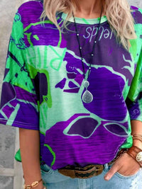 Person wearing a colorful shirt with abstract patterns and text.