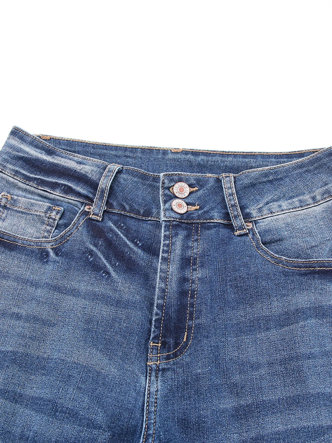 Close-up of blue denim jeans with stitching details on a white background