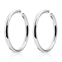 A pair of gold-colored hoop earrings with a reflective surface, placed against a white background.