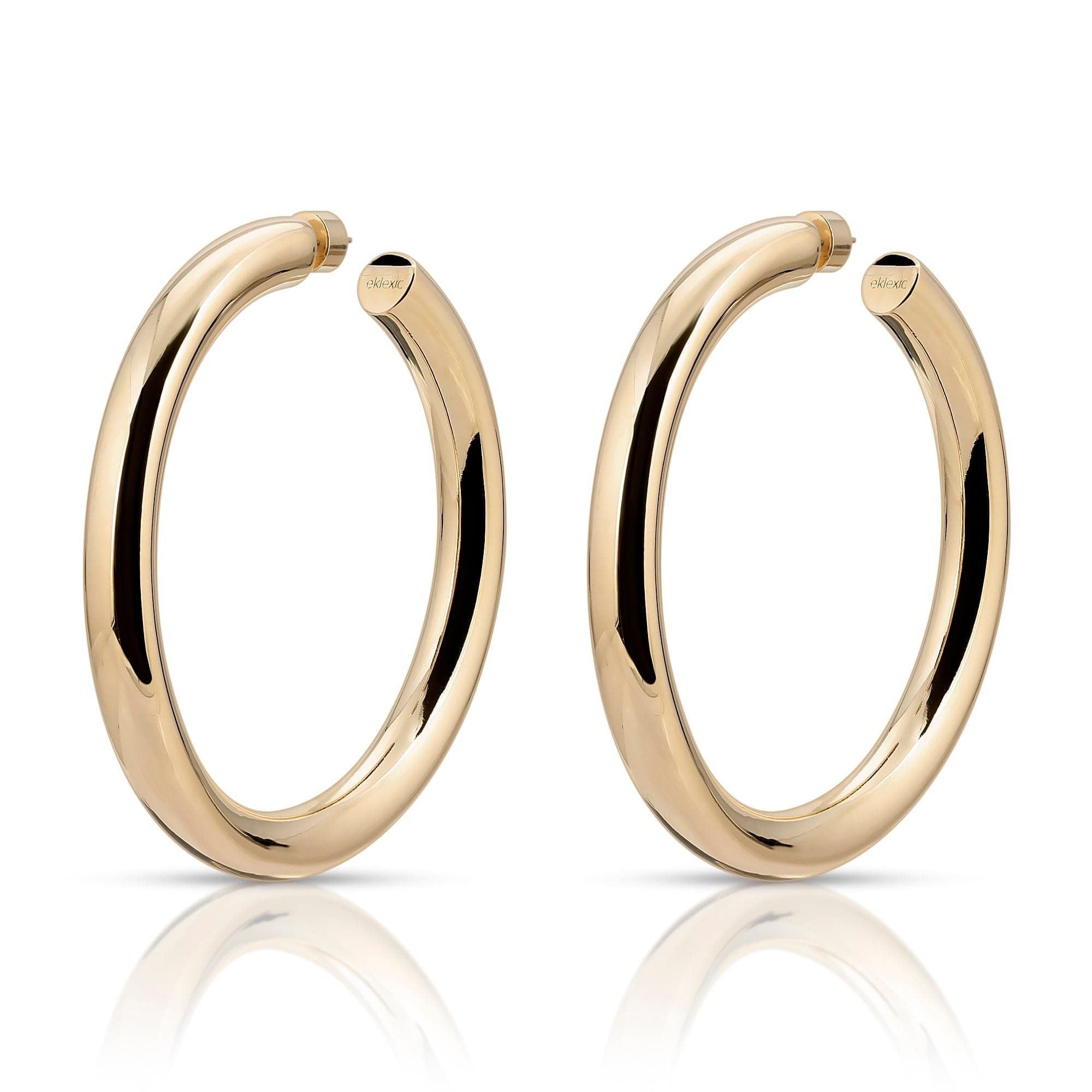 A pair of 2-inch gold-colored hoop earrings with a glossy finish.