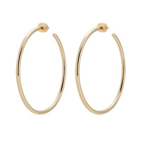 A pair of gold-colored hoop earrings made from recycled brass wire, displayed against a white background.
