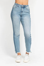 Light blue jeans worn by a person on a white background