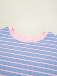 Close-up of a blue and pink striped shirt with a light green background