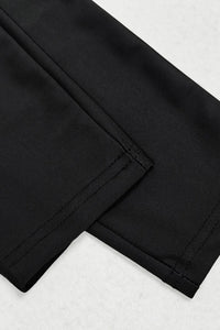 Close-up of black pants on a white background