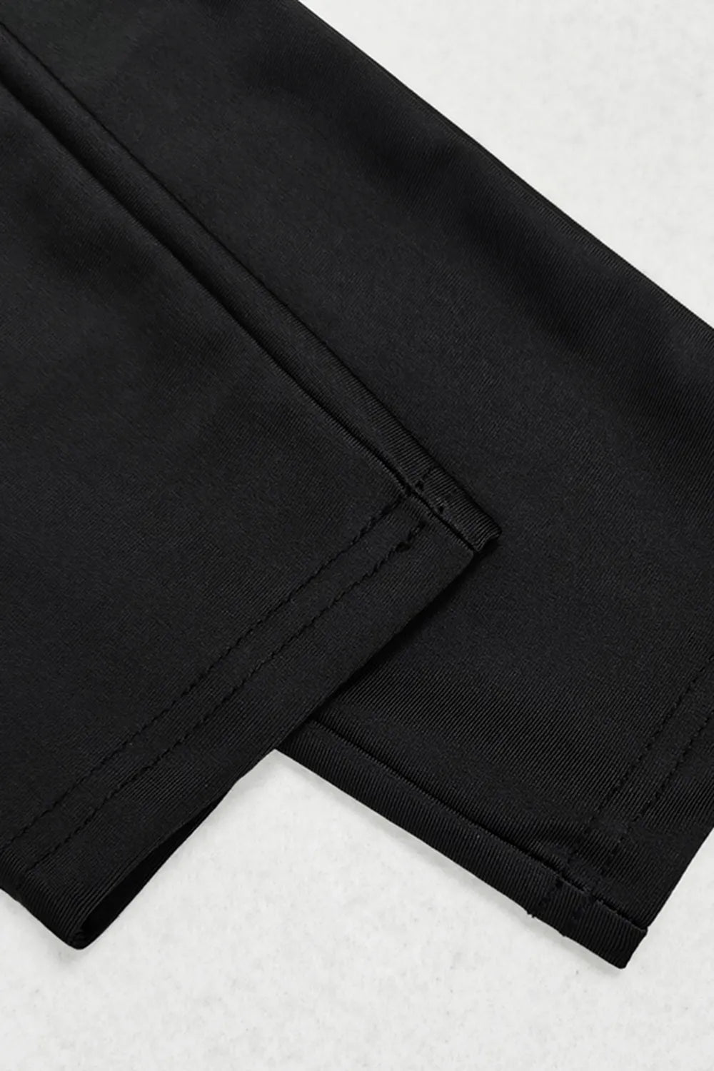 Close-up of black pants on a white background