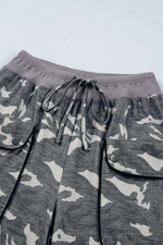 Gray camouflage pants with drawstring on a light gray background