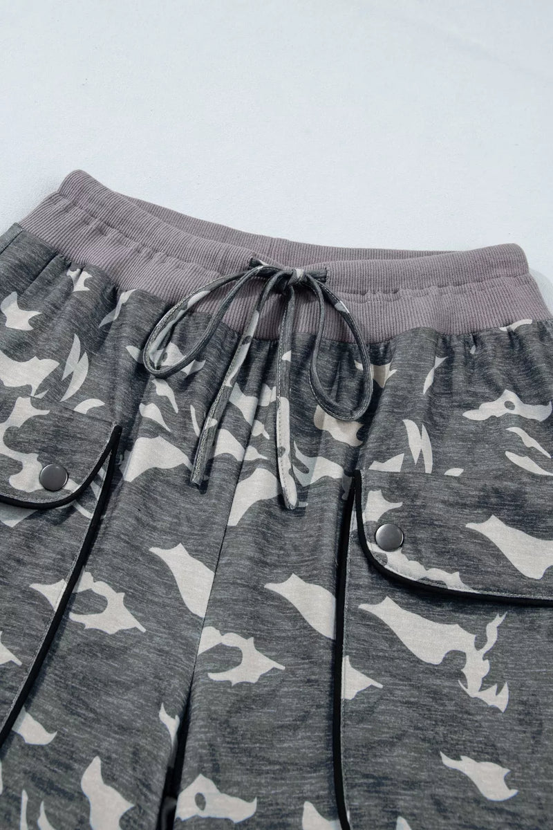 Gray camouflage pants with drawstring on a light gray background
