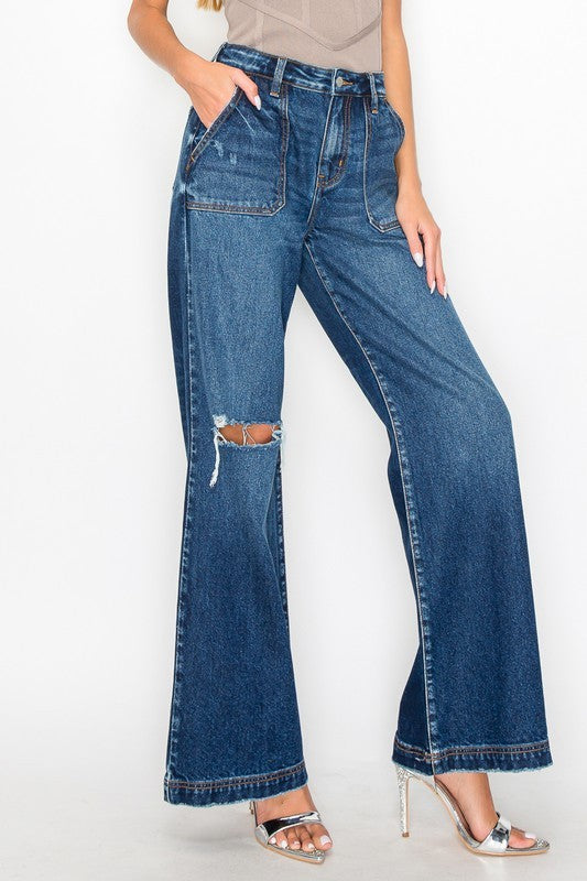 Model showing pocket of ULTRA HIGH RISE RELAXED FLARE JEANS