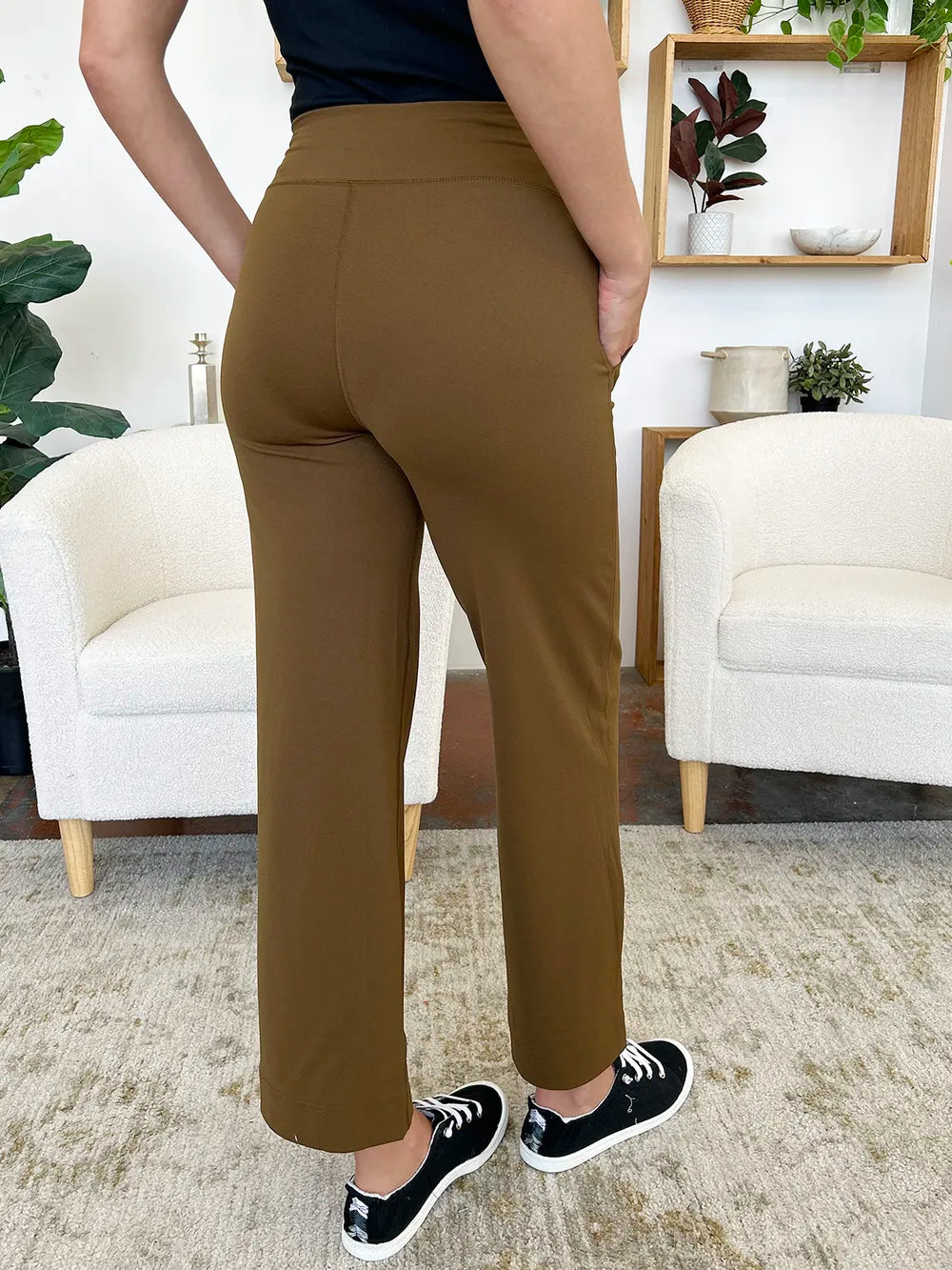 Person wearing brown pants in a living room setting