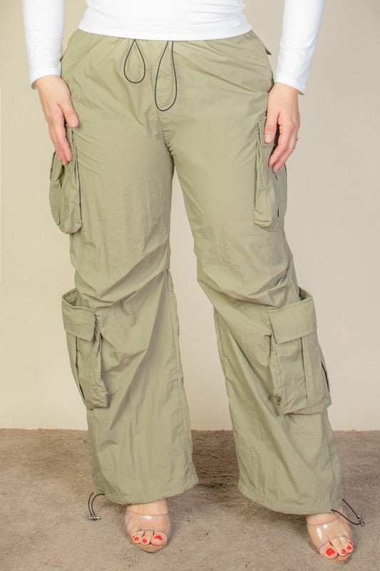 Front view of Plus Flap Pockets Drawstring Parachute Pants green