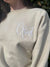 close up view of logo on Child of God Embroidered Sweatshirt