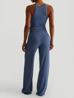 Person wearing a blue jumpsuit on a light gray background