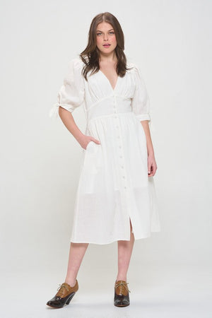 Model showing pocket on PLUS 3/4 PUFF SLV TEXTURED BUTTON DOWN MIDI DRESS