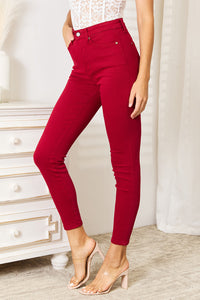 Red pants worn by a person in a minimal indoor setting