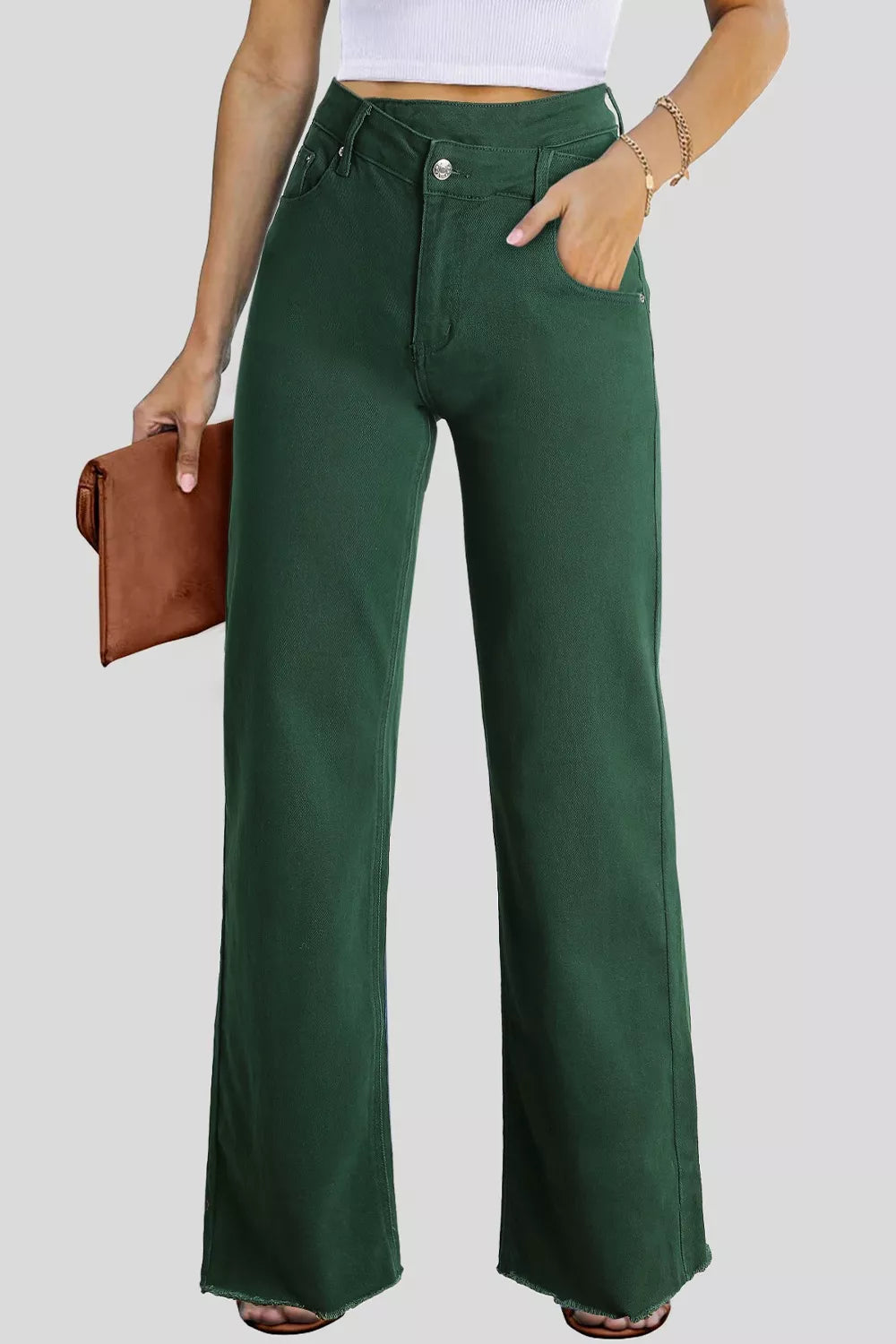 Person wearing green wide-leg pants with a plain background