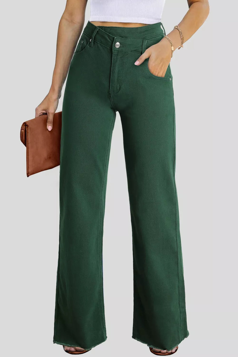 Person wearing green wide-leg pants with a plain background
