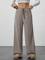 Brown wide-leg pants worn by a person on a plain background