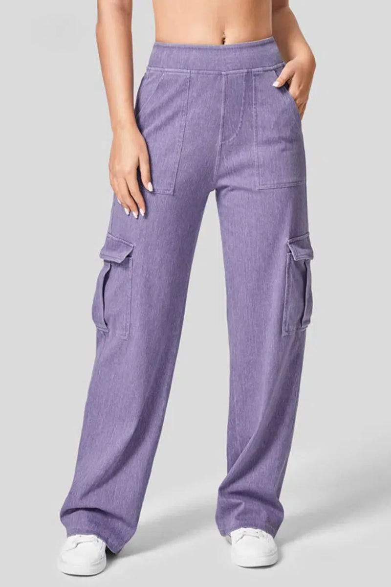 Purple cargo pants worn by a person on a gray background