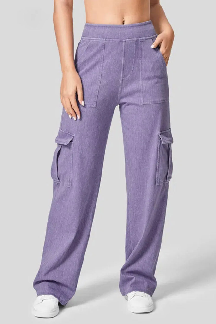 Purple cargo pants worn by a person on a gray background