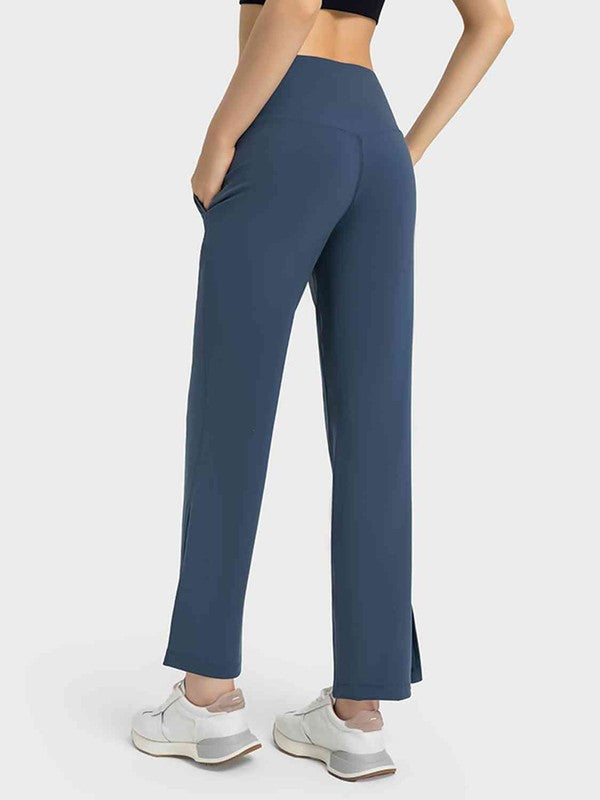 Person wearing blue high-waisted pants on a white background