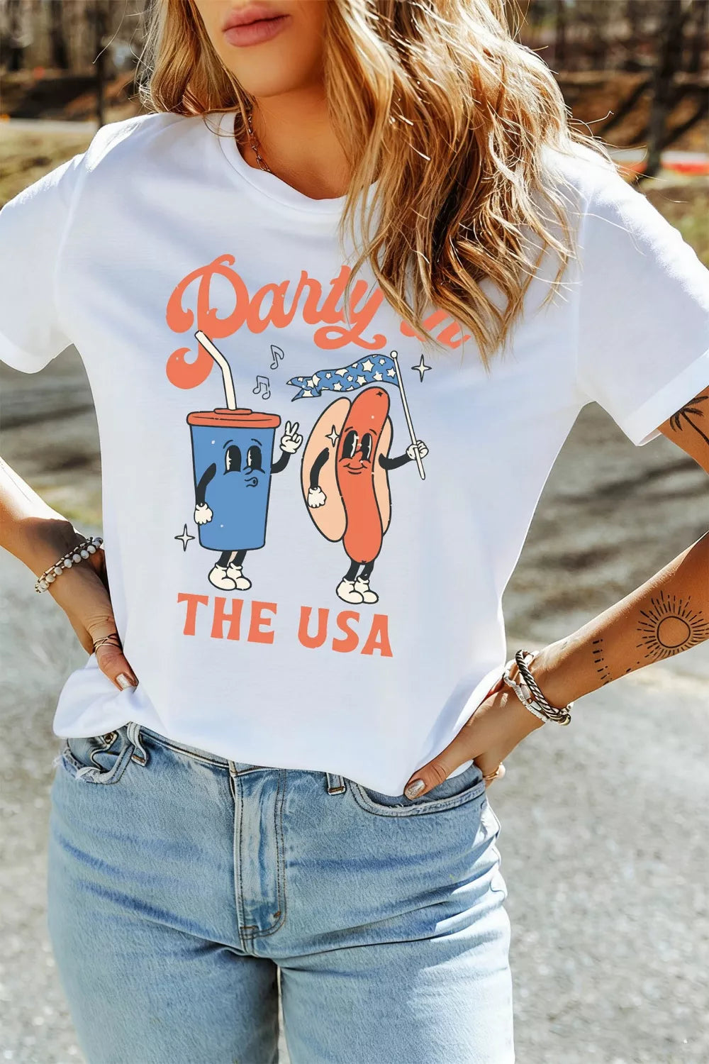 Person wearing a white t-shirt with a colorful graphic design and text.
