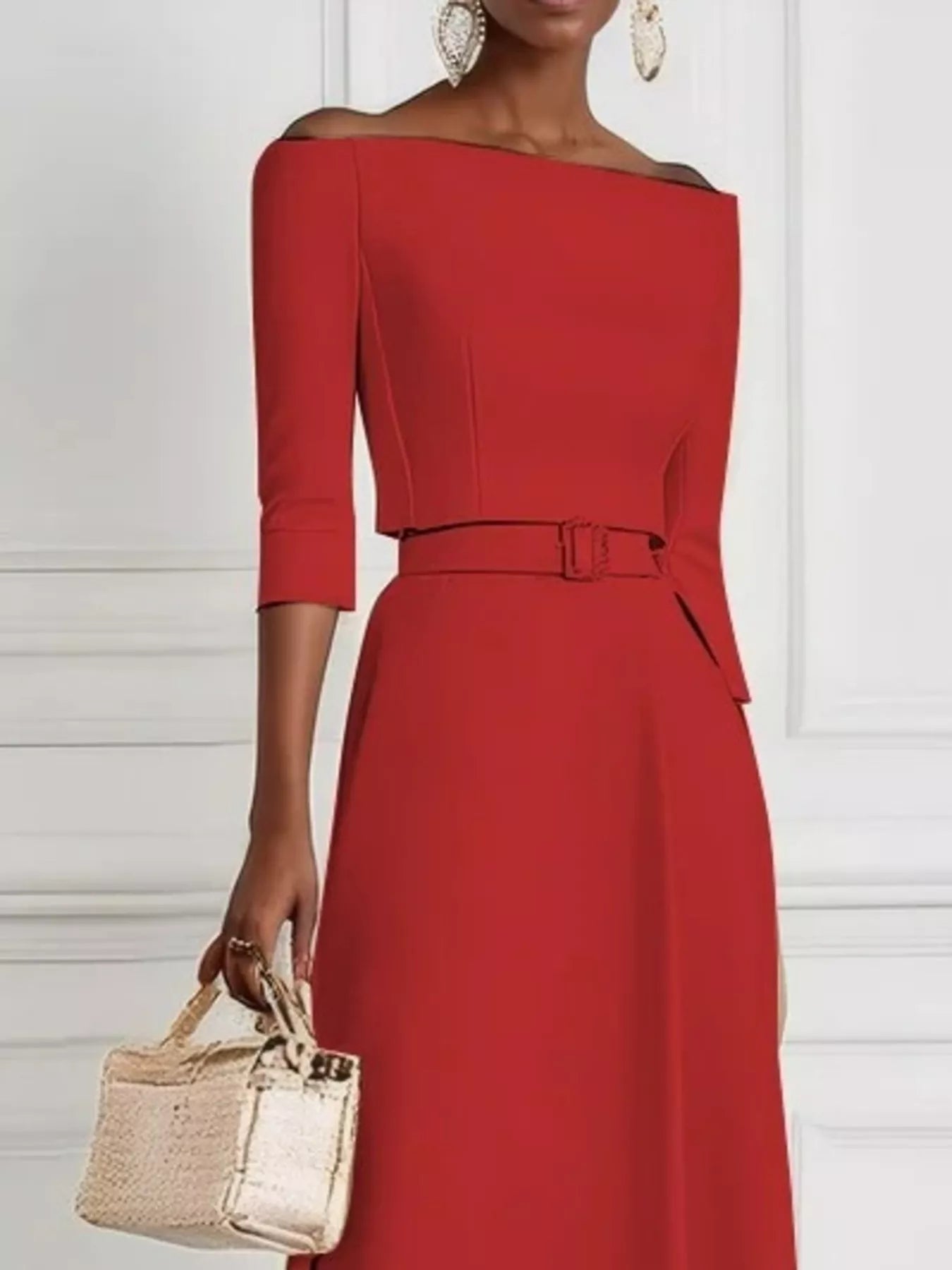 Red off-shoulder dress worn by a person with a white background