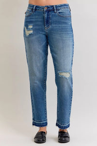 Blue jeans with distressing on a plain background