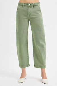Green jeans worn by a person on a white background