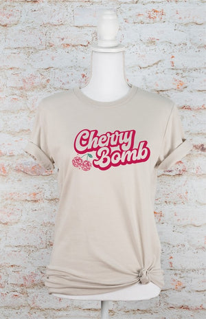 Pic of Cherry Bomb Disco Ball Soft style Tee with a wall background 