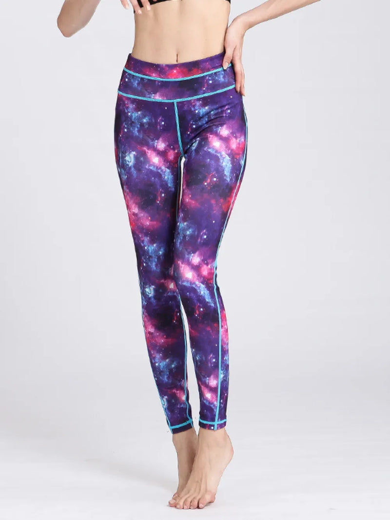 Galaxy-themed leggings worn by a person on a white background