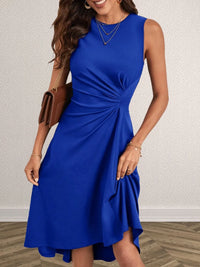 Woman wearing a blue dress with a plain background