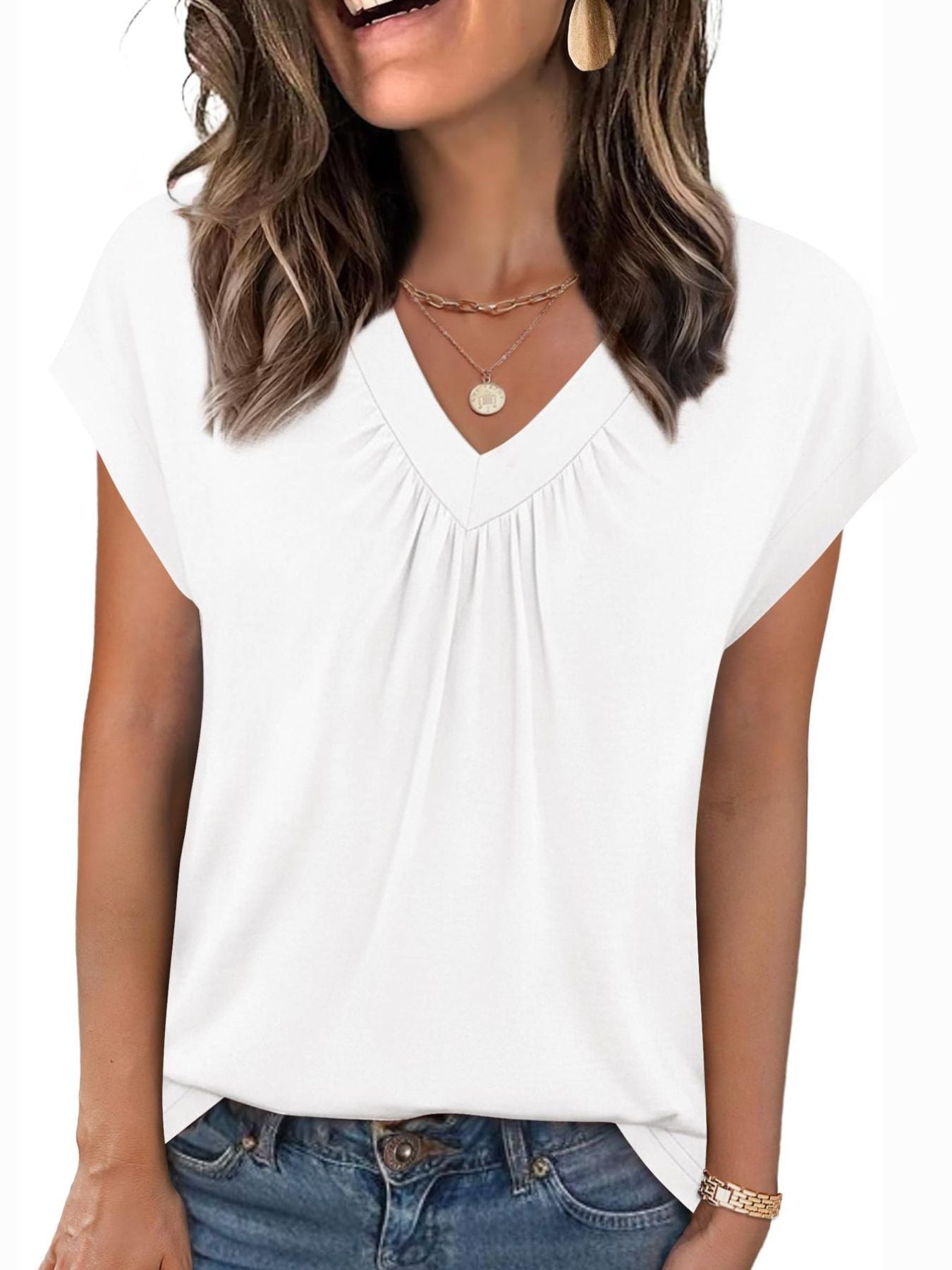Woman wearing a white blouse with short sleeves and blue jeans on a white background