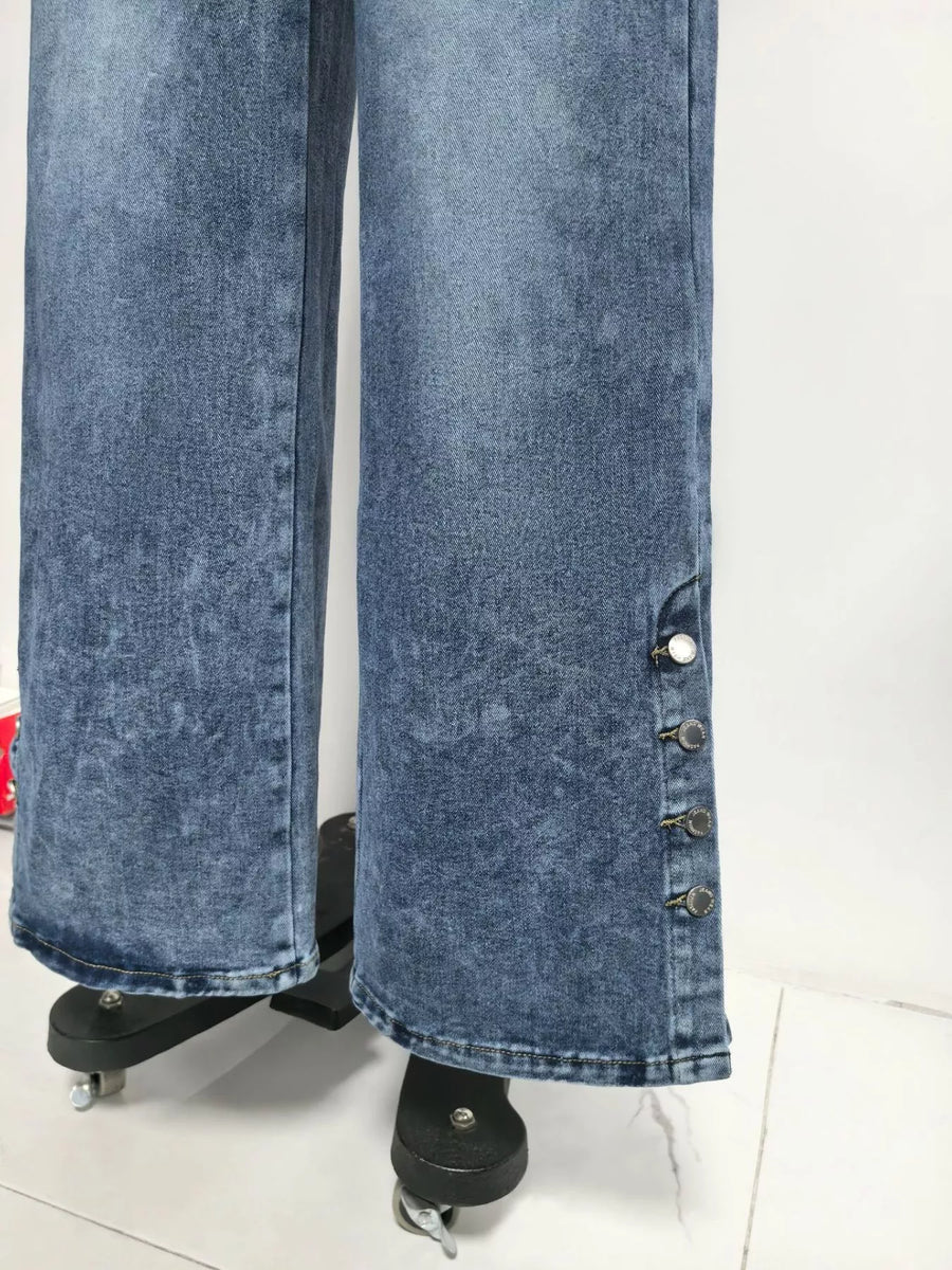 Blue acid-wash jeans on a stand against a white background
