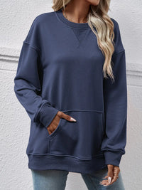 Person wearing a navy blue sweatshirt against a light gray background
