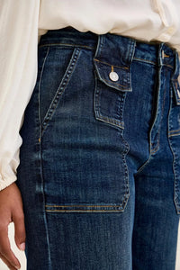 Close-up of blue jeans with a white shirt underneath