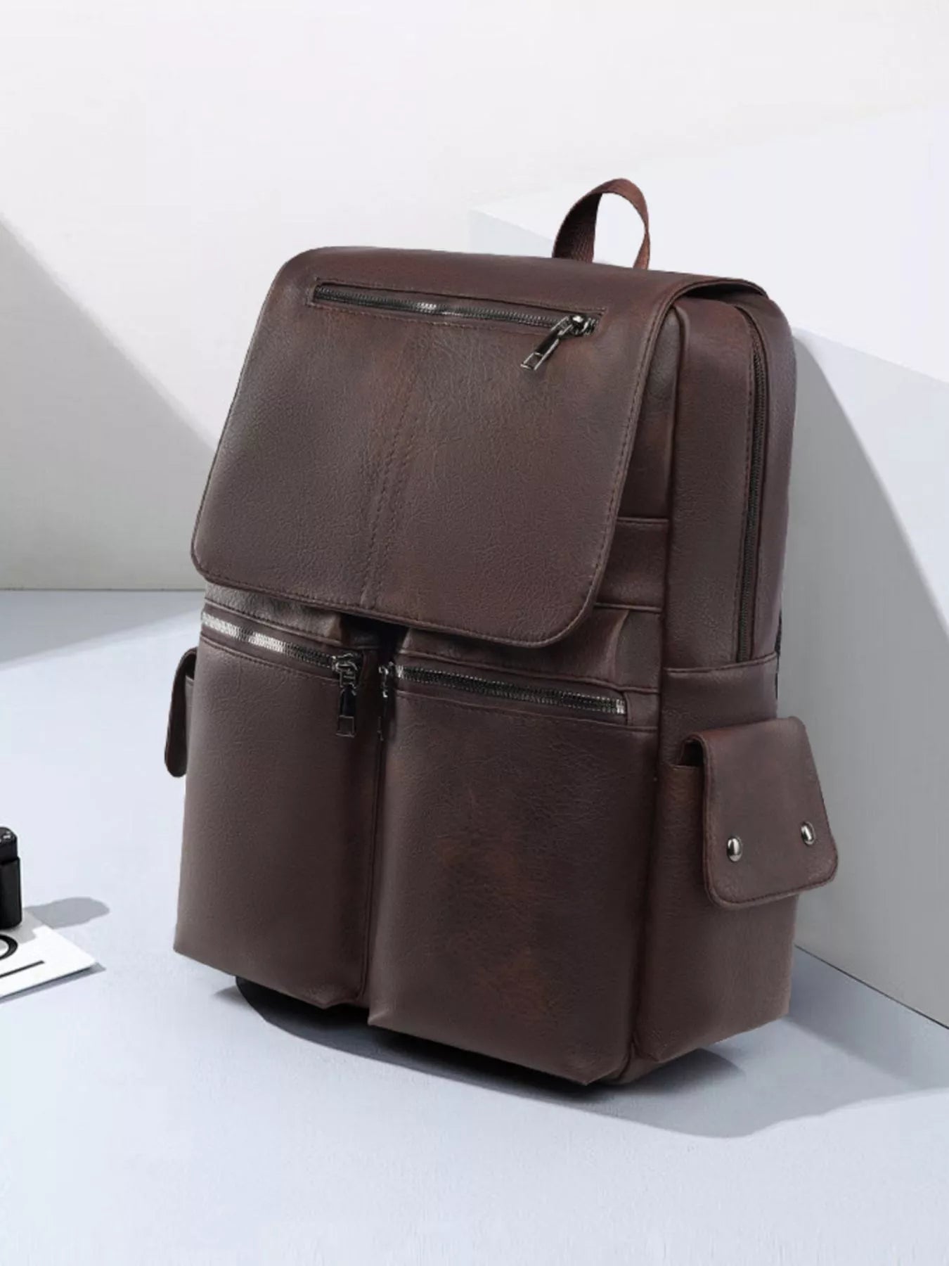 Brown leather backpack on a white background