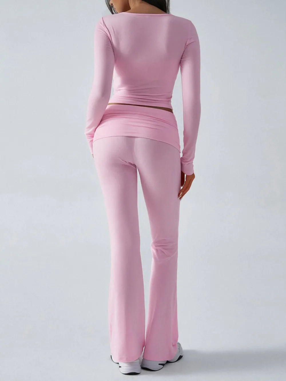 Person wearing a pink athletic outfit on a white background