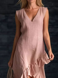 Woman wearing a pink dress against a dark background