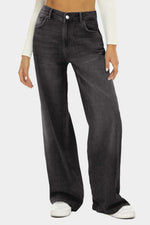 Person wearing black wide-leg jeans on a white background