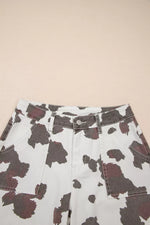 Cow print shorts on a beige background