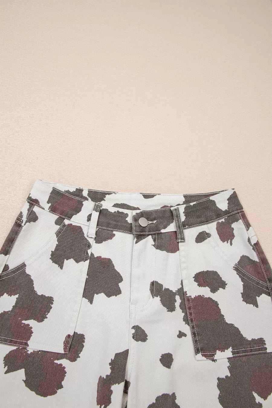 Cow print shorts on a beige background