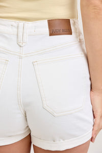 White denim shorts with a Judy Blu label on a neutral background