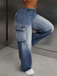Person wearing high-waisted blue jeans with cargo pockets against a neutral background