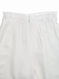 White lace-trimmed pants on a white background