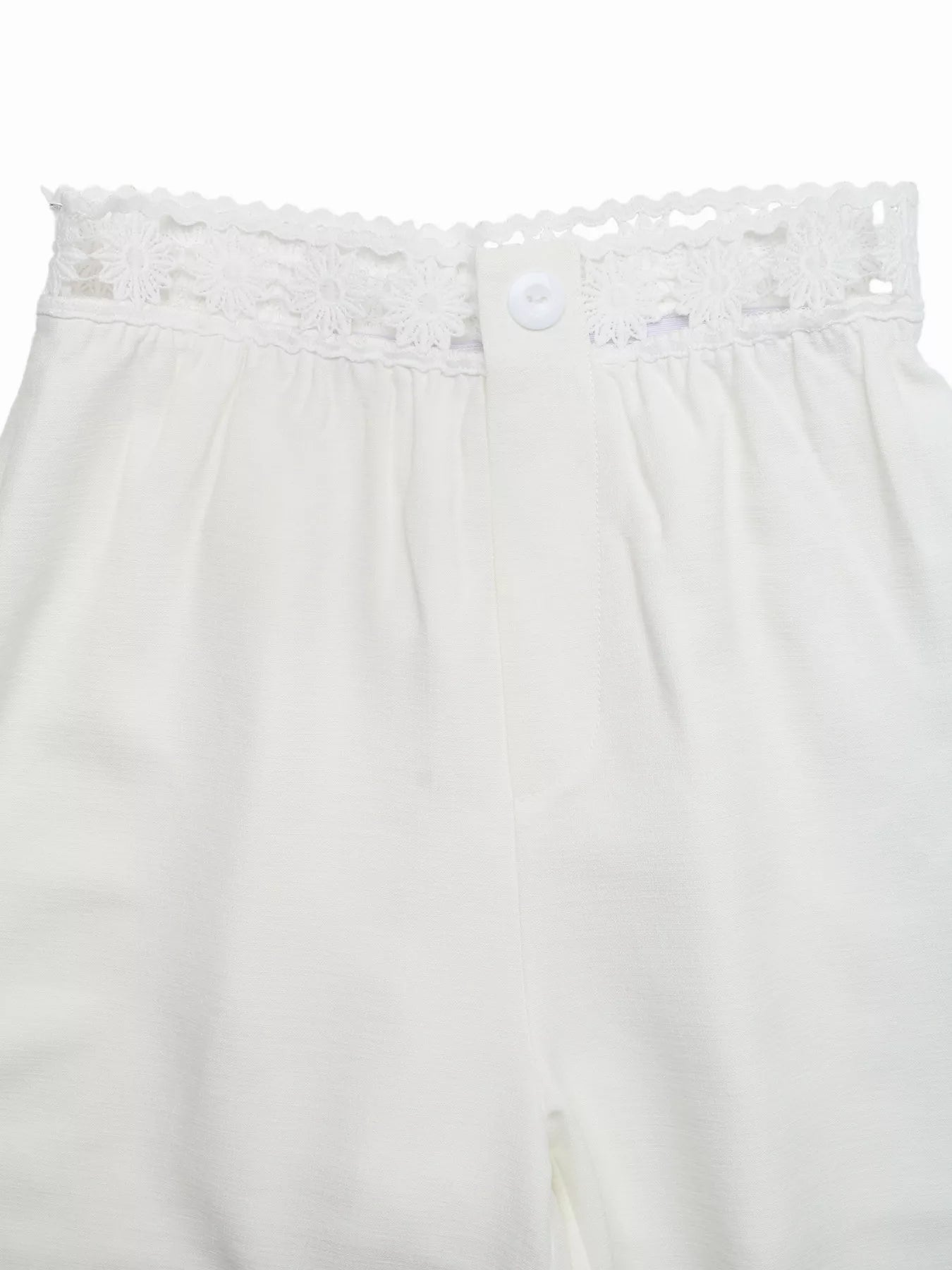 White lace-trimmed pants on a white background