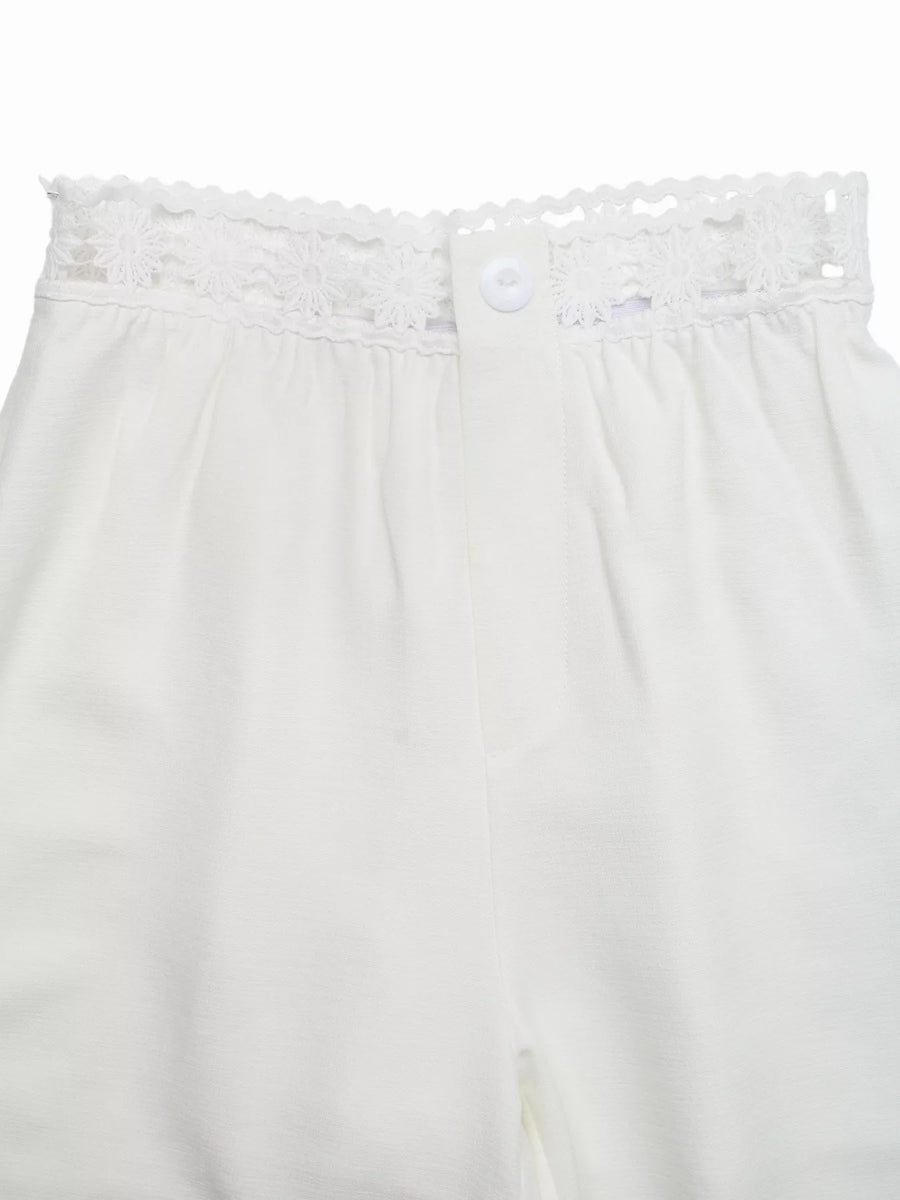 White lace-trimmed pants on a white background