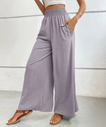 Person wearing light purple wide-leg pants against a white background