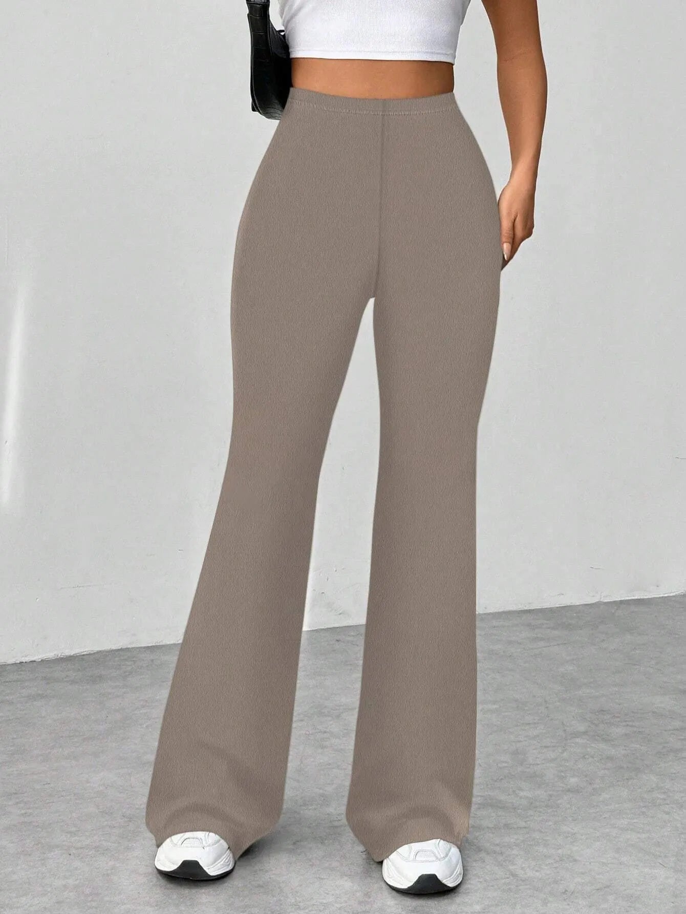 Brown wide-leg pants worn by a person on a plain background